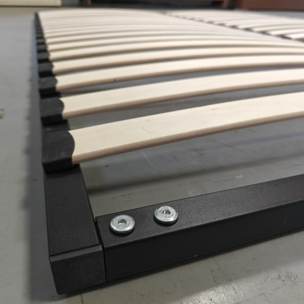 sturdy black metal frame of bed slat support